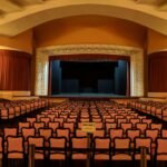 white-and-black chairs near stage inside building