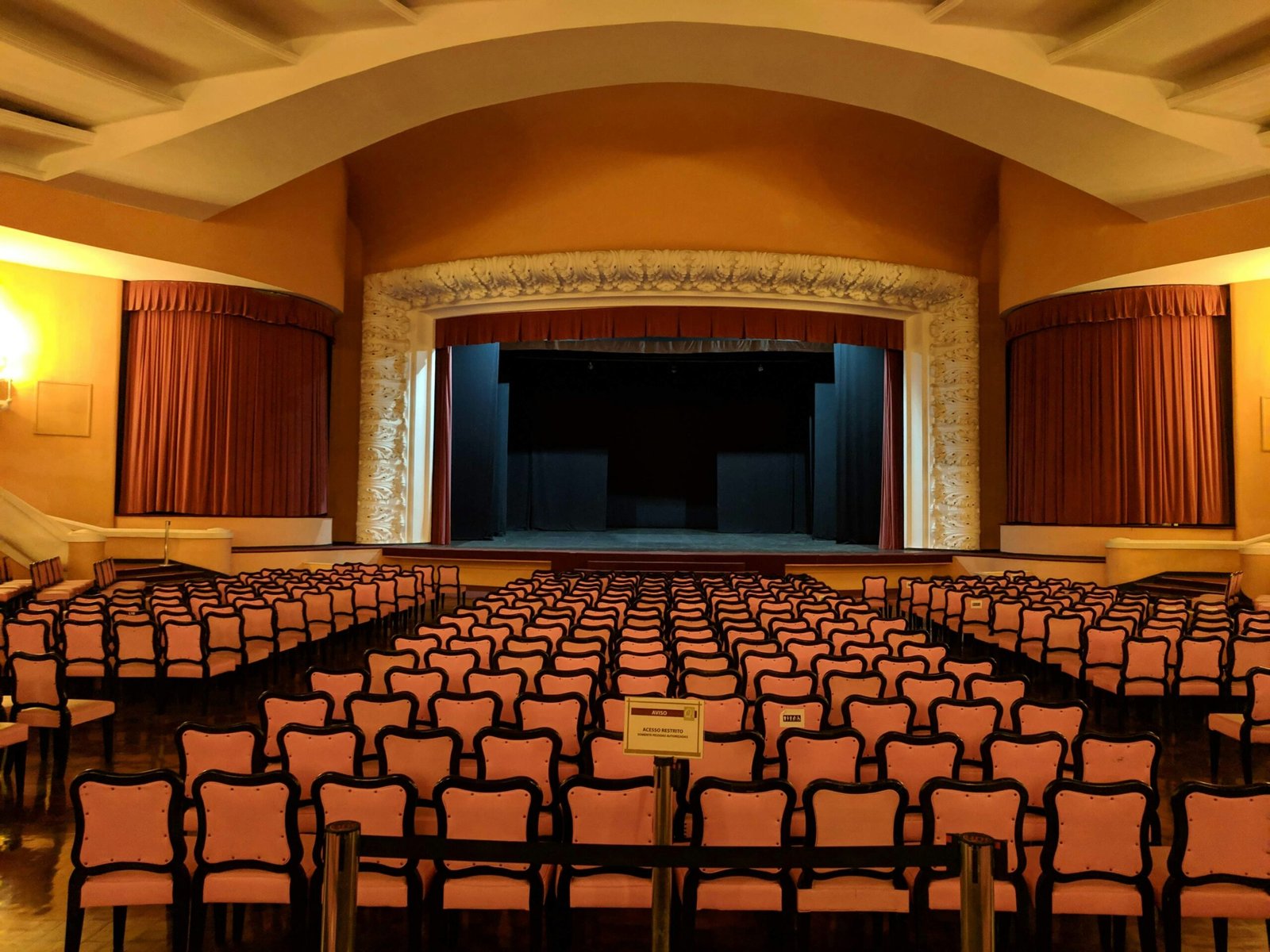 white-and-black chairs near stage inside building